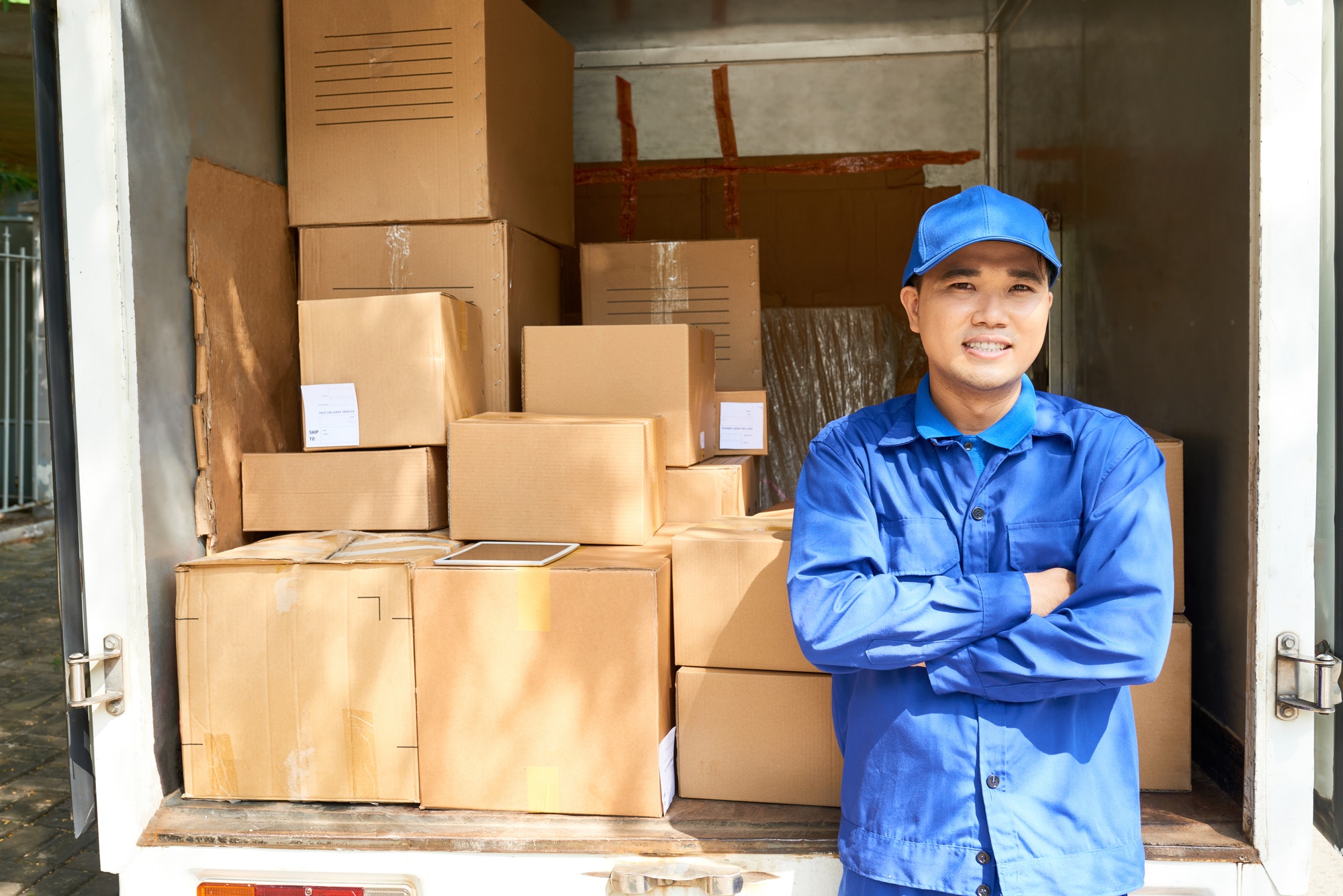 Courier standing at truck loaded truck