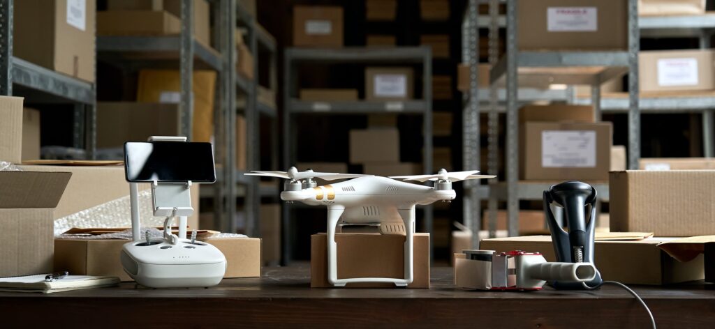 Table with aircraft drone for shipping parcels delivery in warehouse, banner.